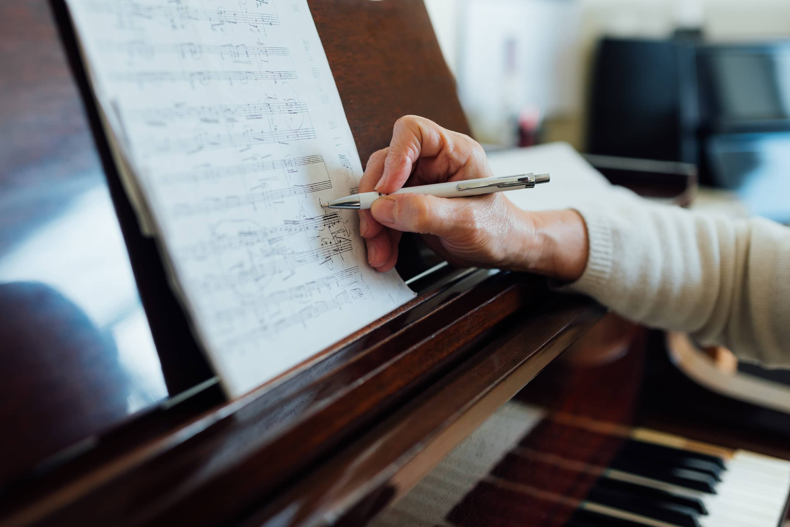 writing notes on sheet music close-up